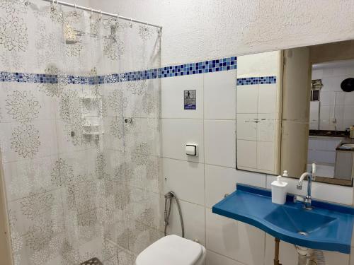 a bathroom with a toilet and a sink and a mirror at Casarão Centenário in Passos