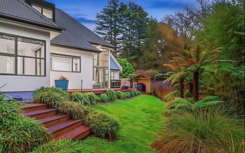 a house with a yard with green grass at Christchurch Airport House in Christchurch