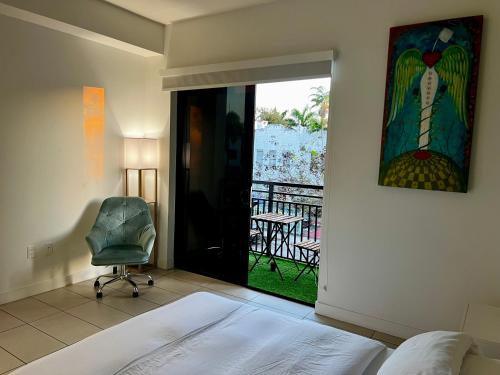 a bedroom with a bed and a chair and a window at The Art House Little Havana in Miami