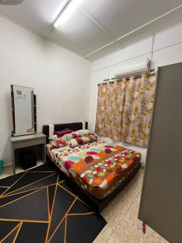 a bedroom with a bed and a mirror in it at HOMESTAY AYER MOLEK Malay ONLY in Air Molek