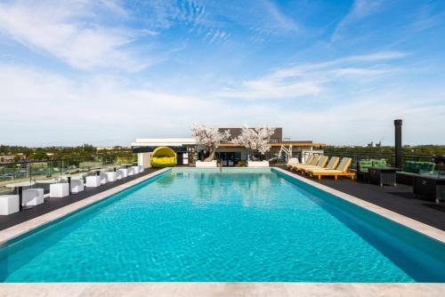 a swimming pool on the roof of a building at KOOSH - Boutique Aparthotel in Fort Lauderdale