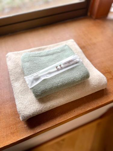 a towel sitting on a window sill with a toothbrush at 民泊Nao in Minami Alps