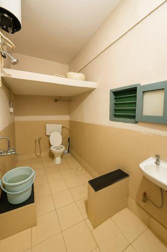 a bathroom with a toilet and a sink at Classic Jayanagar House for Veg only in Bengaluru