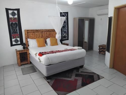 a bedroom with a large bed in a room at Sunshinevibe guest house in Kasane