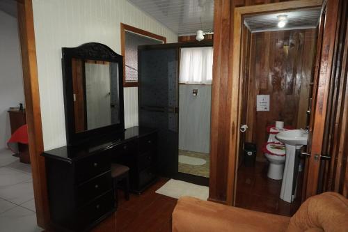 a bathroom with a sink and a mirror and a toilet at Campo Azul #2 - Monteverde in Monteverde Costa Rica