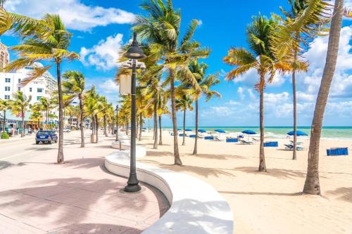 a street with palm trees on the beach at Cozy Little Bungalow in Fort Lauderdale