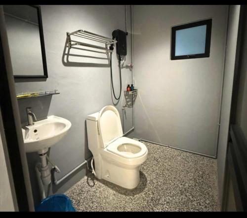 a bathroom with a toilet and a sink at travellersloft 168 in Johor Bahru