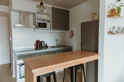 a kitchen with a wooden counter top in a room at Apartamento tranquilo iluminado ideal para descansar in Montevideo