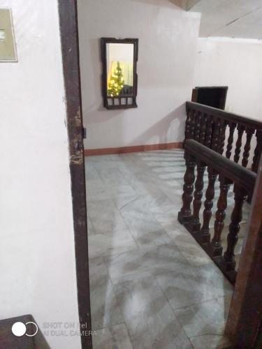 a hallway with a mirror and a stair case at Mike Saba 