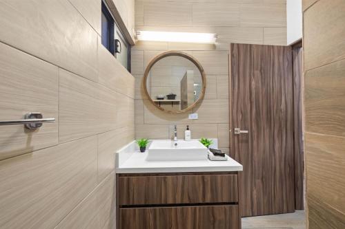 a bathroom with a sink and a mirror at Playas de Tijuana in Tijuana