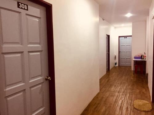 an empty room with a door and a hallway at BENUTHOMEStay in Benut