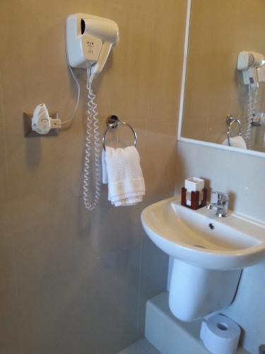 a bathroom with a sink and a phone at Apartamento Alemania in Temuco