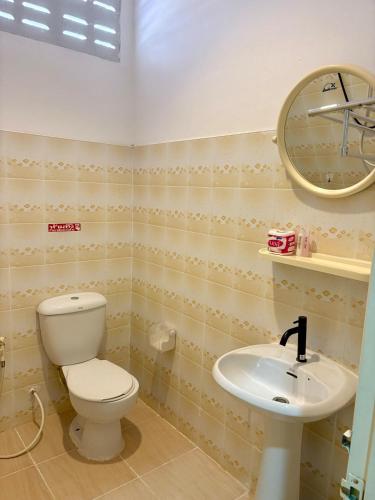 a bathroom with a toilet and a sink at Lanta Grand House in Ko Lanta