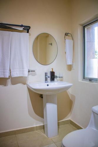 a bathroom with a sink and a mirror at Hotel Majo Sayulita in Sayulita