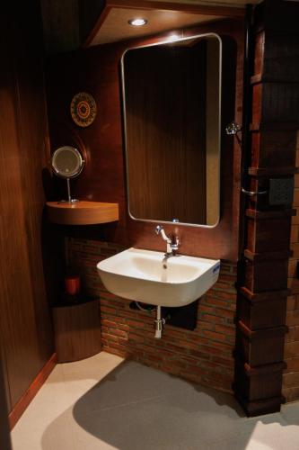 a bathroom with a sink and a mirror at BaanPranwadee in Nong Khai