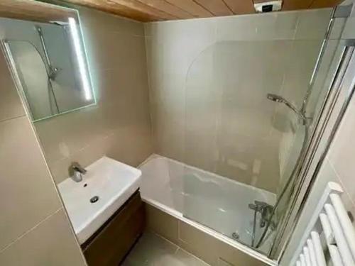 a bathroom with a tub and a sink and a shower at Appartement à Méribel 4 pers, piscine, skis aux pieds - FR-1-411-1007 in Chandon