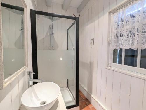 Un baño blanco con inodoro y ducha. en Charmant hébergement avec parc et étang à Mers-sur-Indre - FR-1-591-771, en Bonnet