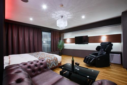 柏市にあるホテルリンクス柏市豊四季店のベッドとソファのあるホテルの部屋