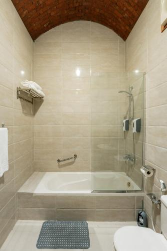 a bathroom with a tub and a toilet and a sink at opal legacy luxor in Luxor