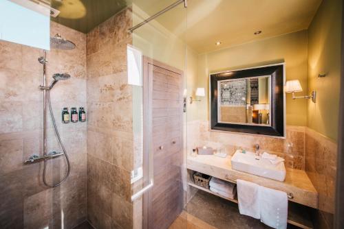 a bathroom with a sink and a shower at BALTAZÁR Boutique Hotel in Budapest