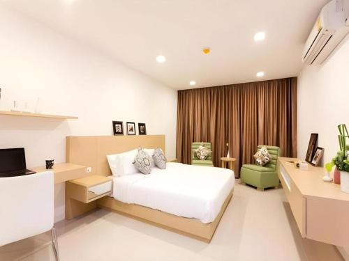 Postel nebo postele na pokoji v ubytování Landmark Residence