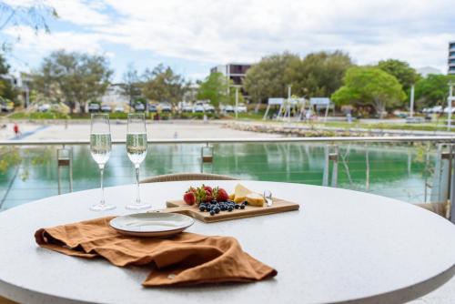 a table with glasses of wine and a plate of food at Maraboo Island - Luxury, Beachfront, family friendly, Sauna, close to Fremantle & Rottnest Island Ferry in Coogee