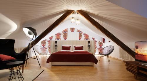 a bedroom with a red bed in a attic at Park Residence Apartments in Bolzano