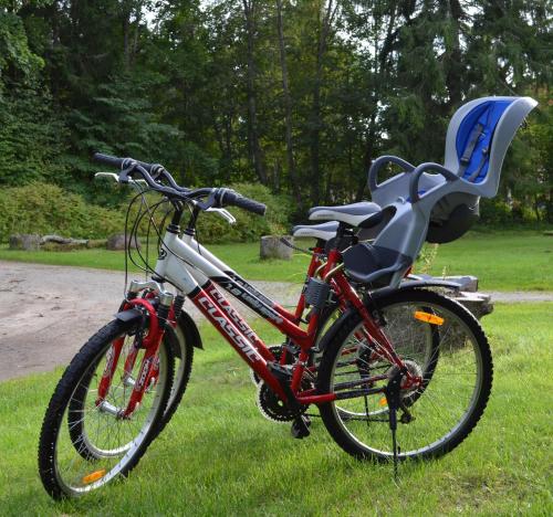 a bike parked in the grass with a chair on it at Liivakell Holiday Homes in Narva-Jõesuu