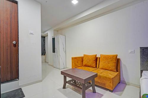 a living room with a couch and a table at FabHotel RK Inn in Pune