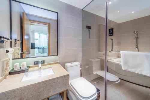 a bathroom with a toilet and a sink and a shower at City Comfort Inn Qingyuan City Plaza Hefu Dongcheng in Xiaoshi
