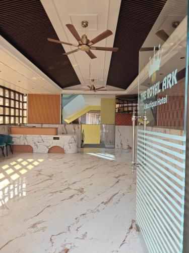 an empty lobby with a ceiling fan and marble floors at The Royal Ark Hotel in Pune