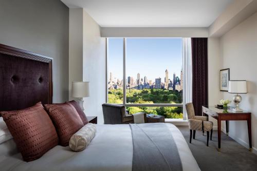 a bedroom with a bed with a view of the city at Trump International New York in New York