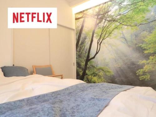 a bedroom with a window with a picture of a forest at Mori no Kabe Tokyo #KT1 in Takahate