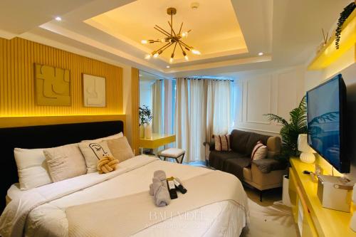 a hotel room with a bed and a television at Bali Videl - Studio with Queen Bed & Beach View in San Fernando