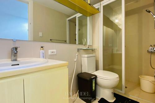 a bathroom with a toilet and a sink and a shower at Bali Videl - Studio with Queen Bed & Beach View in San Fernando