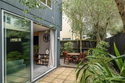 an open patio with a table and chairs at The City Retreat in Christchurch