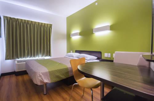 a small hotel room with a bed and a table at Motel 6-South Bend, IN - Mishawaka in South Bend