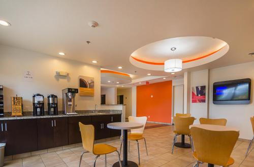 a lobby with a bar with chairs and a table at Motel 6-South Bend, IN - Mishawaka in South Bend