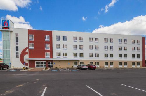 a white and red building with a parking lot at Motel 6-South Bend, IN - Mishawaka in South Bend