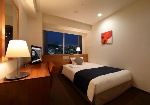 Postel nebo postele na pokoji v ubytování Oriental Hotel Hiroshima