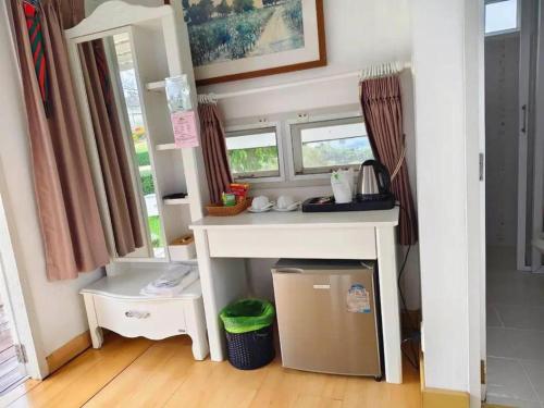 a kitchen with a counter and a table in a room at Montana Cotswolds Resort in Ban Kom