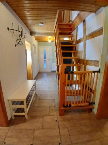 a hallway with a wooden staircase and a stair case at Ferienhaus Plech in Plech