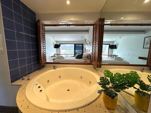 a large tub in a bathroom with a large mirror at BlueWater Penthouse Guest Suite 3 in Newport