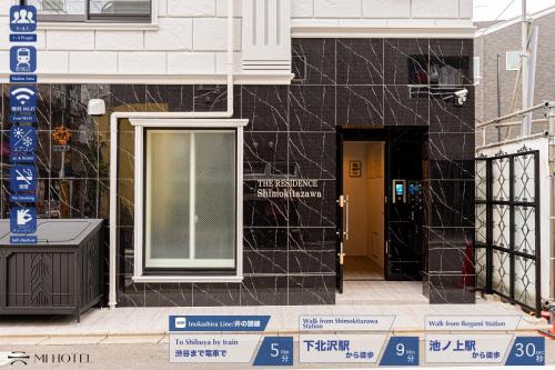 a building being constructed with black tile on it at Mi-HOTEL SHIMOKITAZAWA in Tokyo
