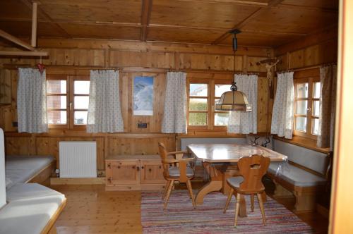 a dining room with a table and chairs in a cabin at Tiroler Blockhaus in Imst