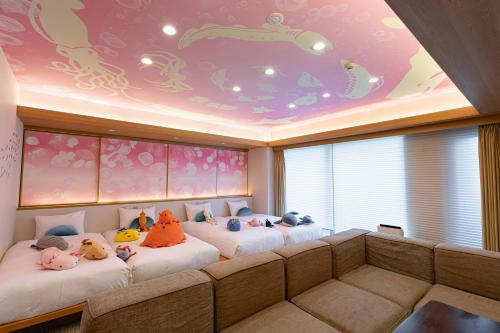 a room with two beds with stuffed animals on them at GOLD STAY Nagoya Osu in Nagoya