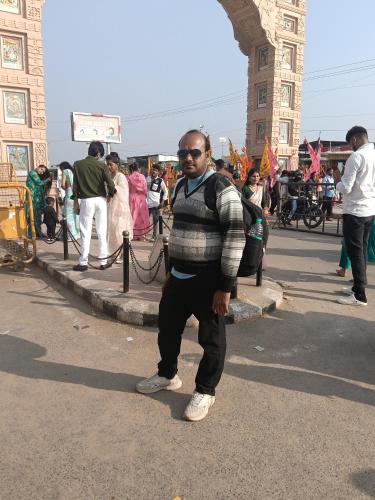 a man standing in the street in front of a building at Govardhan Seva Sadan govardhan in Govardhan