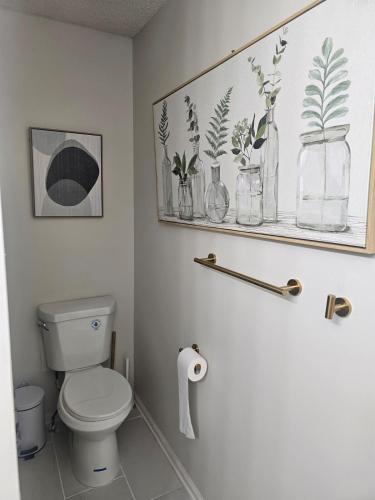 a bathroom with a toilet and a shelf with plants at Atlanta 3 Bedroom Home - by PriMary EVolution Properties in Atlanta