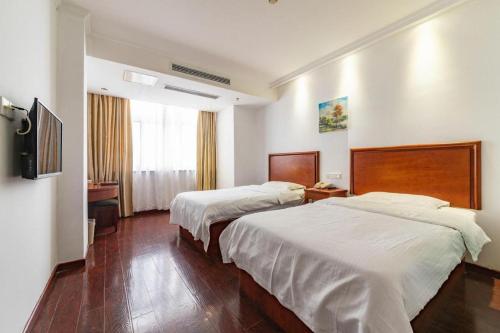 Ένα ή περισσότερα κρεβάτια σε δωμάτιο στο GreenTree Inn Yancheng Vehicle Administrative office Test Center Express Hotel