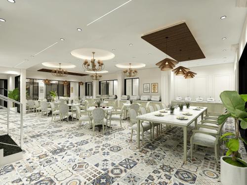 a dining room with tables and chairs in a room at Studio by Jardin in Indore